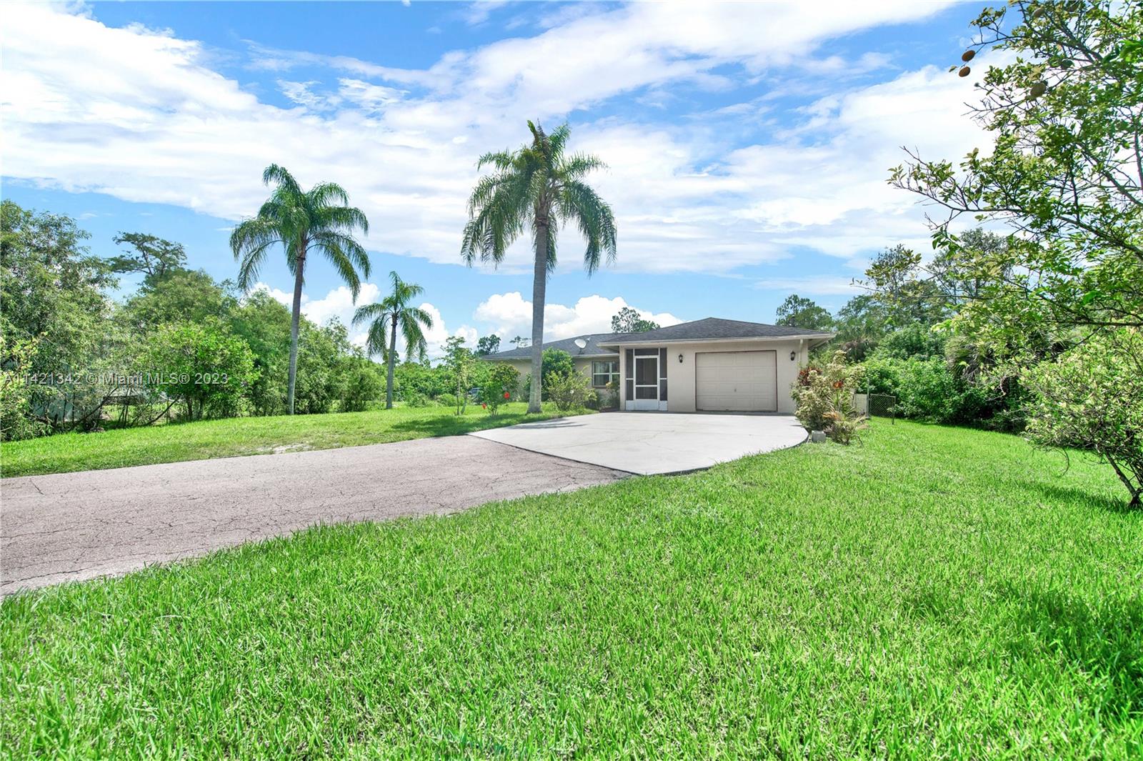 1480 Southwest 17th Street Naples, FL 34117 - Photo 30 of 36 a front view of a house with garden and trees