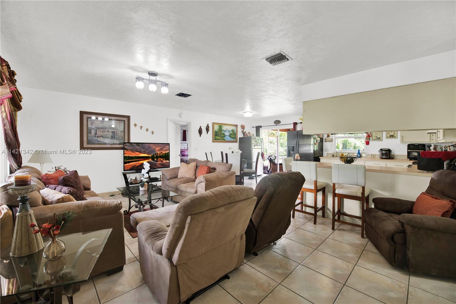 1480 Southwest 17th Street Naples, FL 34117 - Photo 5 of 36 a living room with furniture and a flat screen tv