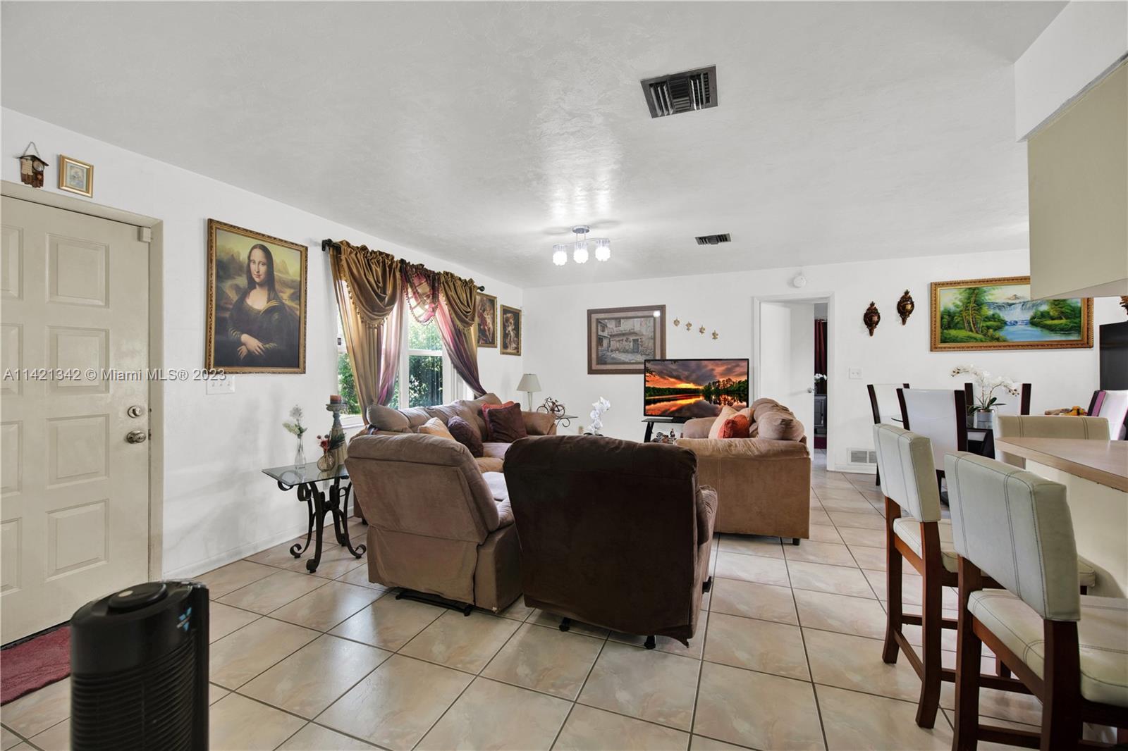 1480 Southwest 17th Street Naples, FL 34117 - Photo 6 of 36 a living room with furniture and a flat screen tv