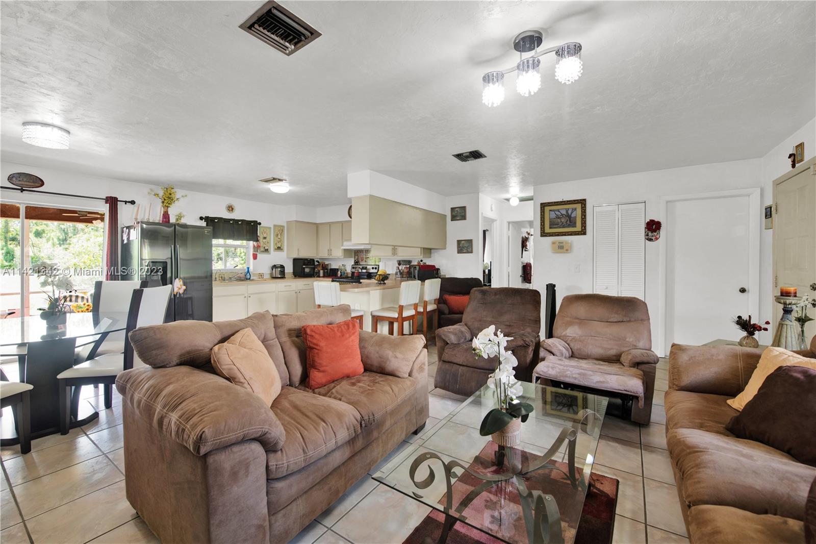 1480 Southwest 17th Street Naples, FL 34117 - Photo 7 of 36 a living room with furniture kitchen view and a large window