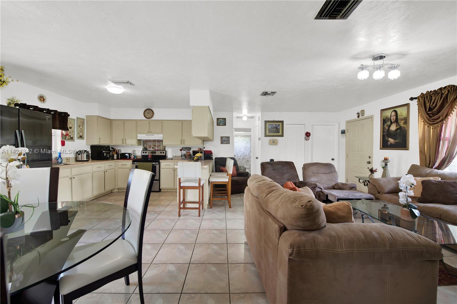 1480 Southwest 17th Street Naples, FL 34117 - Photo 8 of 36 a living room with furniture and a flat screen tv