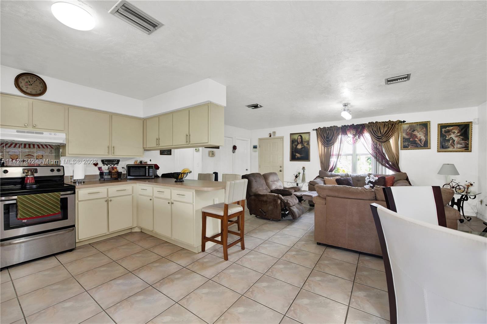 1480 Southwest 17th Street Naples, FL 34117 - Photo 9 of 36 a kitchen with sink cabinets and window
