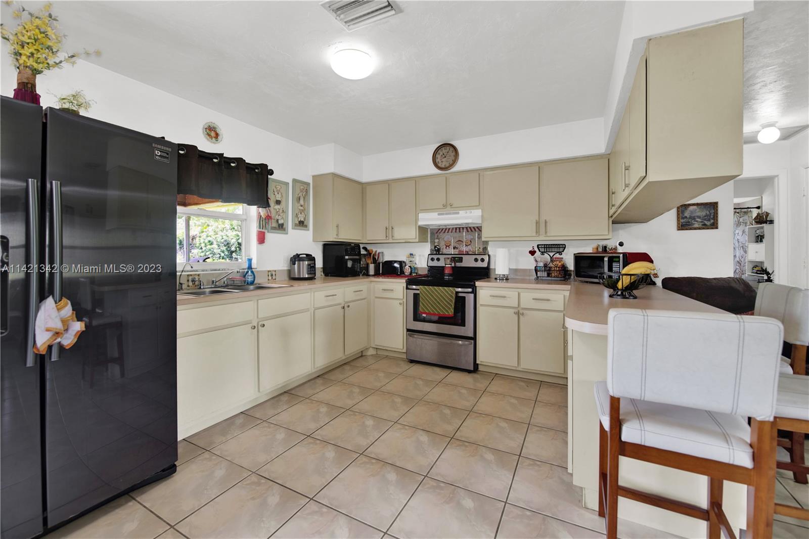 1480 Southwest 17th Street Naples, FL 34117 - Photo 10 of 36 a kitchen with cabinets and chairs