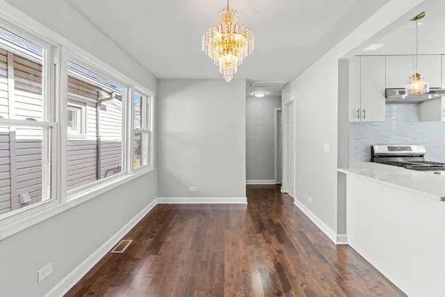 a view of livingroom with kitchen and hardwood floor