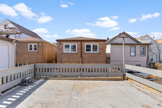 a view of a house with wooden fence
