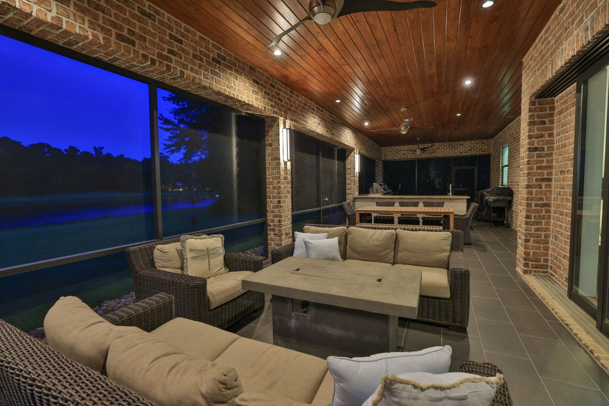 6918 Comanche Bend Montgomery, TX 77316 - Photo 7 of 50 Plenty of space for entertaining, the expansive screened-in outdoor living area allows you to enjoy the fresh air, waterfront views, and peaceful setting year-round with no bugs!