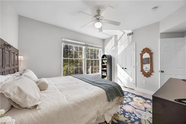 a bedroom with a large bed and a window