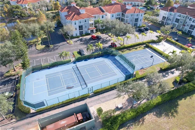 an aerial view of a house with a garden and lake view