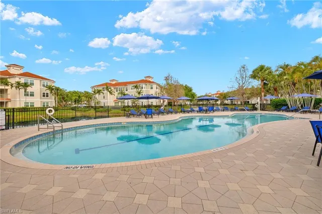 a view of swimming pool with a yard and lake view