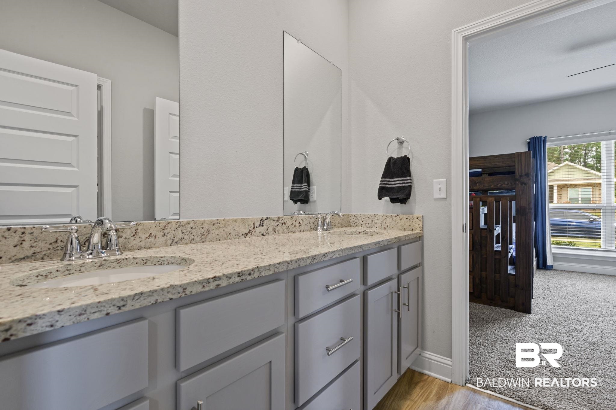 2183 Meadowview Loop Semmes, AL 36575 - Photo 17 of 58 Full bath featuring double vanity, light carpet, and light wood-style flooring