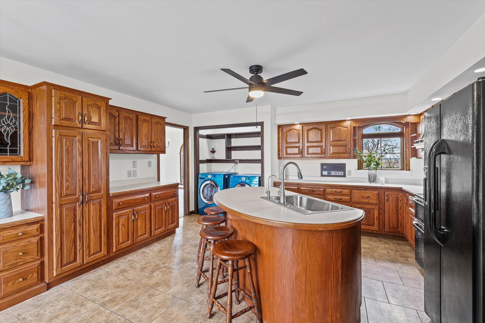 7961 North 3000 E Road Forrest, IL 61741 - Photo 18 of 66 a kitchen with stainless steel appliances granite countertop a refrigerator a sink a dining table and chairs with wooden floor