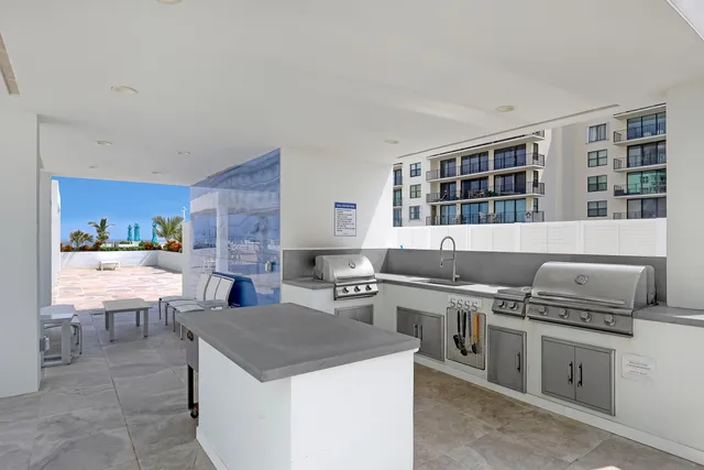 a dining room with stainless steel appliances kitchen island granite countertop a dining table and chairs