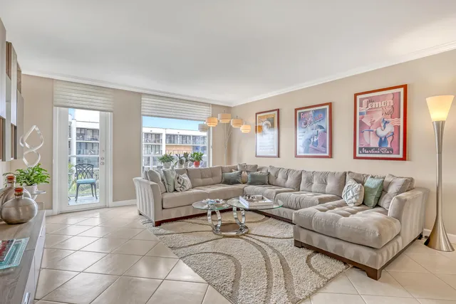 a living room with furniture and a potted plant