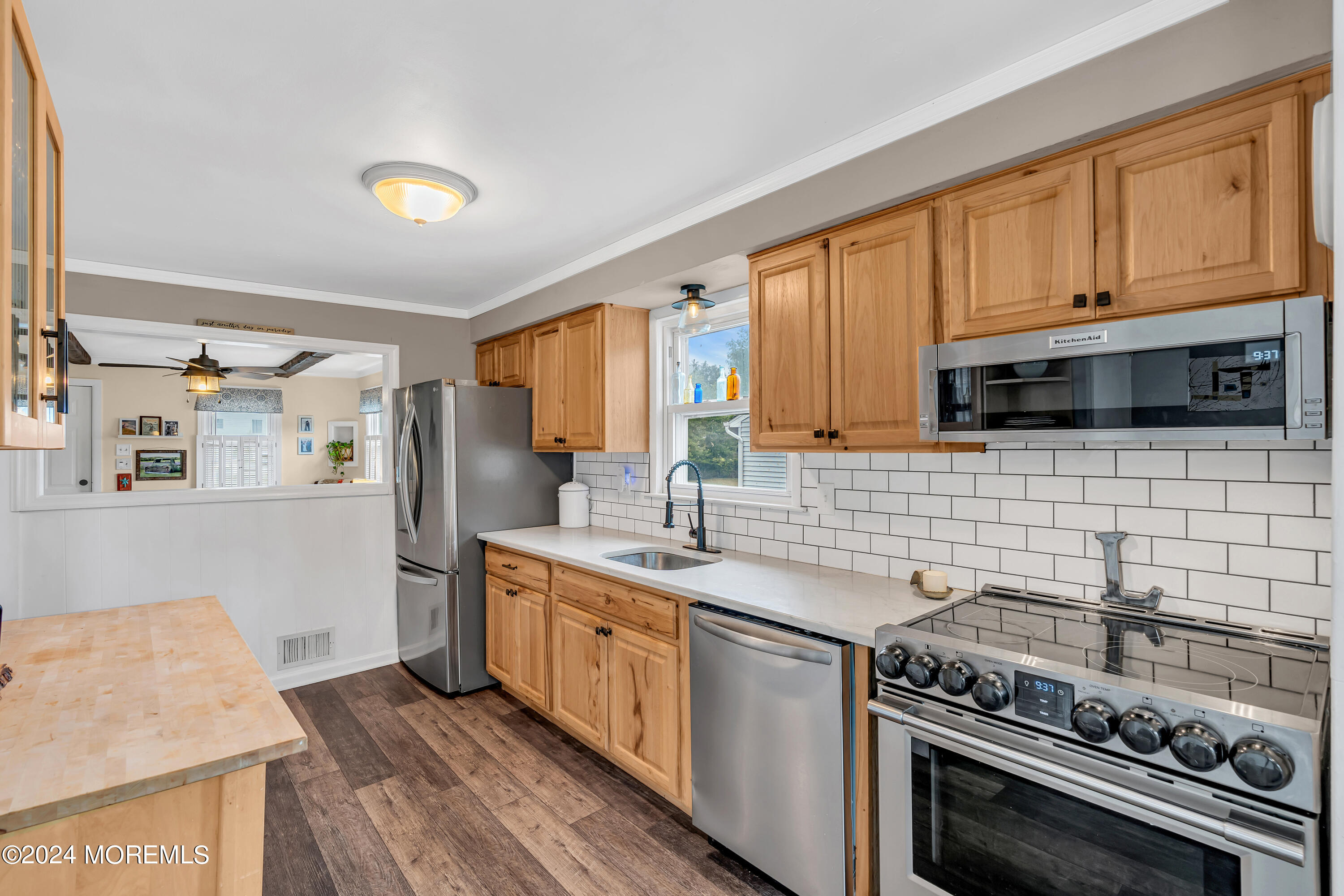 1507 Edgemere Road Wall, NJ 07719 - Photo 12 of 32 a kitchen with stainless steel appliances a stove sink and cabinets