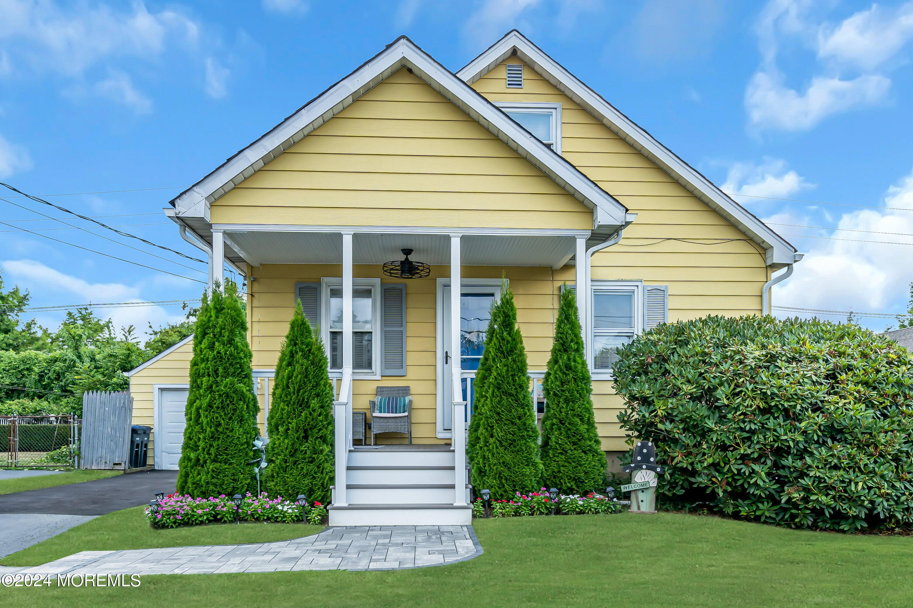 1507 Edgemere Road Wall, NJ 07719 - Photo 32 of 32 a view of a house with brick walls and a yard with plants