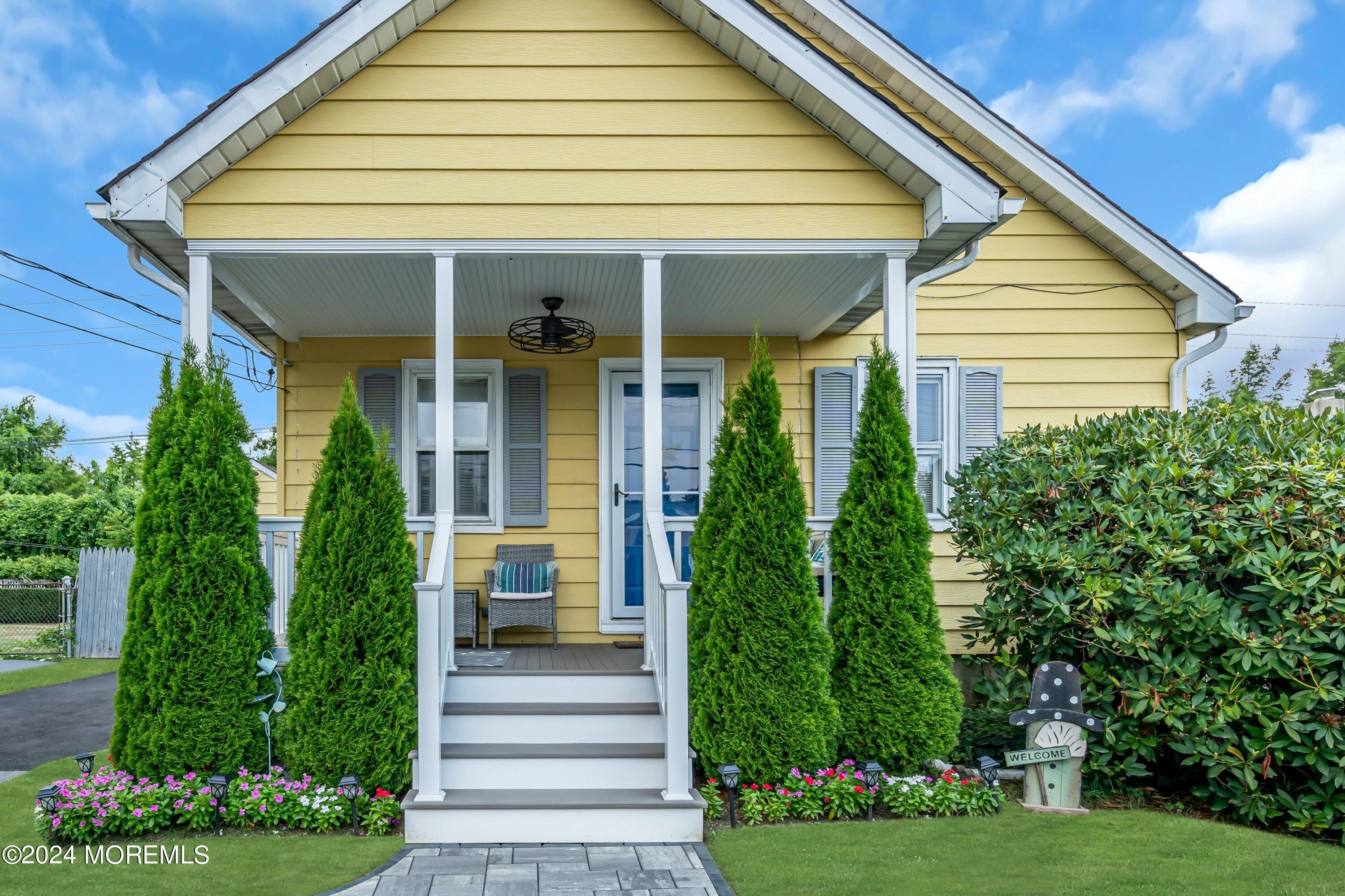 1507 Edgemere Road Wall, NJ 07719 - Photo 4 of 32 a front view of a house with a garden