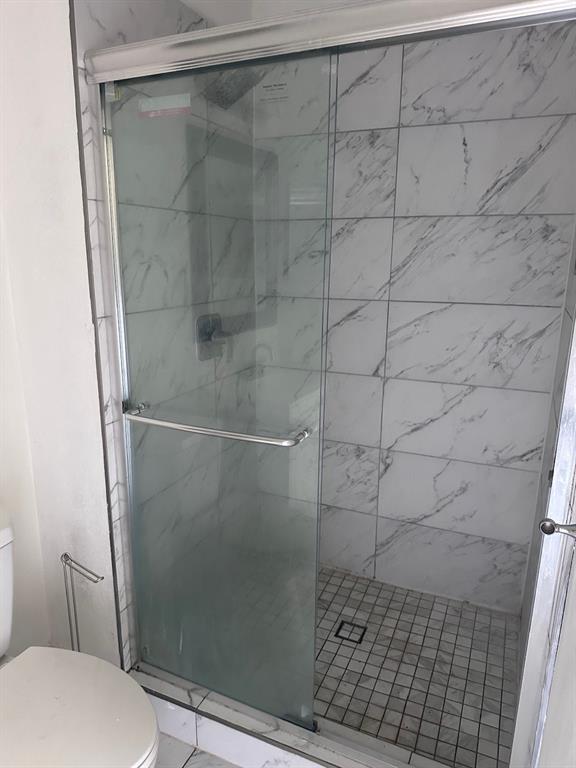2103 Carlton Road Carrollton, TX 75007 - Photo 5 of 18 a bathroom with a shower and toilet