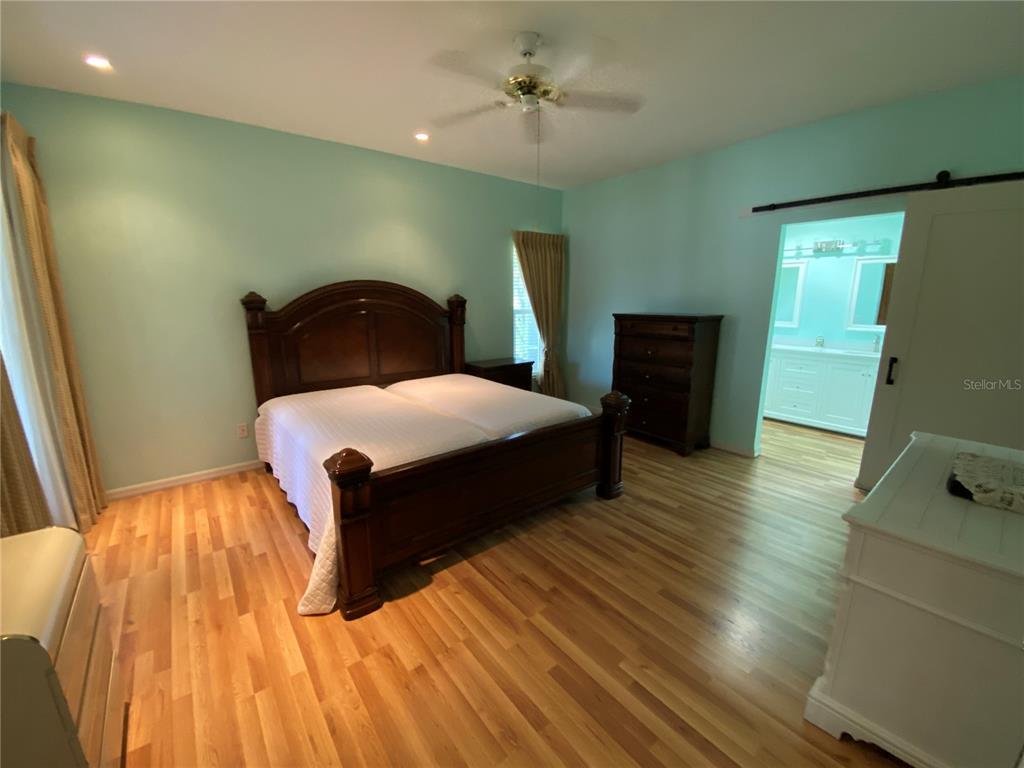 4202 Hammersmith Drive Clermont, FL 34711 - Photo 13 of 73 a bedroom with a bed and wooden floor