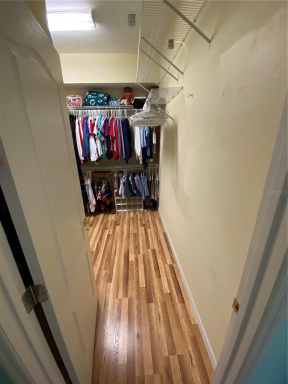4202 Hammersmith Drive Clermont, FL 34711 - Photo 19 of 73 a view of a hallway with wooden floor