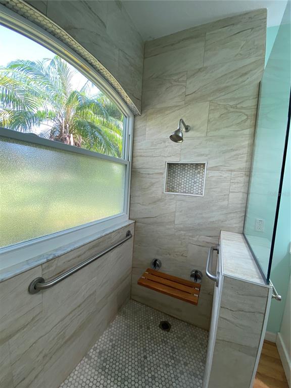 4202 Hammersmith Drive Clermont, FL 34711 - Photo 23 of 73 a bathroom with a window and a bath tub