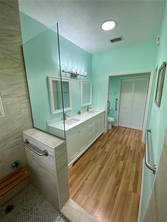 4202 Hammersmith Drive Clermont, FL 34711 - Photo 25 of 73 a bathroom with a sink and a mirror