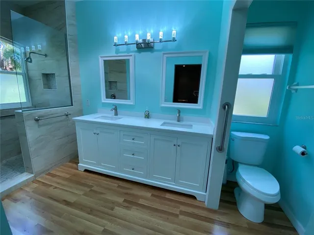 a kitchen with stainless steel appliances a refrigerator a sink a stove and island