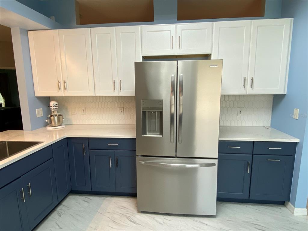 4202 Hammersmith Drive Clermont, FL 34711 - Photo 43 of 73 a kitchen with a refrigerator sink and cabinets