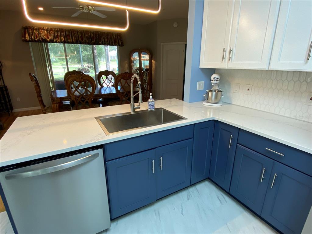 4202 Hammersmith Drive Clermont, FL 34711 - Photo 44 of 73 a kitchen with a sink and cabinets