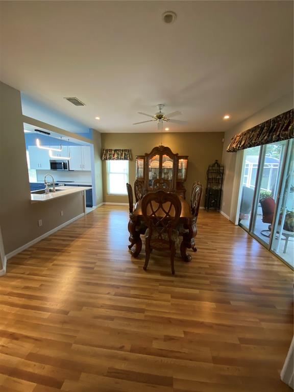 4202 Hammersmith Drive Clermont, FL 34711 - Photo 46 of 73 a living room with furniture floor to ceiling window and wooden floor