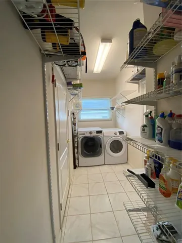 a view of a balcony with chair potted plants and large tree