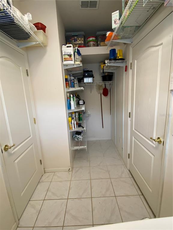 4202 Hammersmith Drive Clermont, FL 34711 - Photo 50 of 73 a view of walk in closet with clothes and shoes