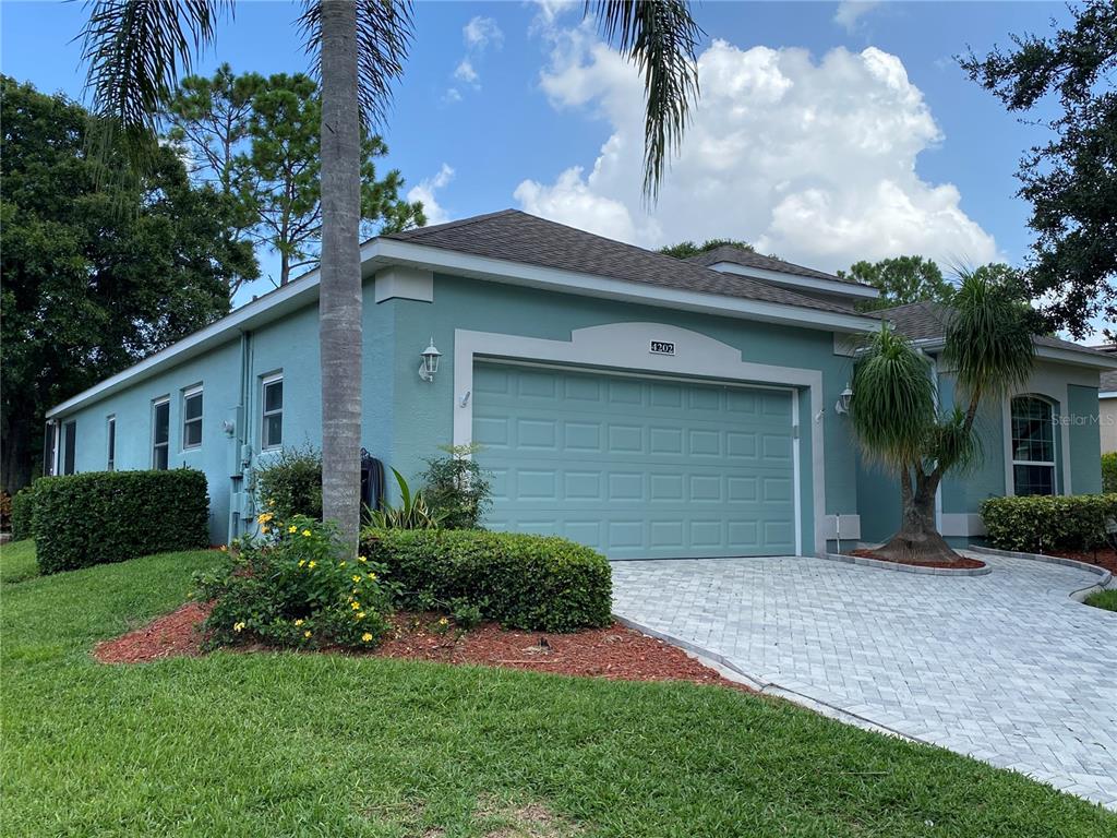4202 Hammersmith Drive Clermont, FL 34711 - Photo 5 of 73 a front view of a house with a yard and garage