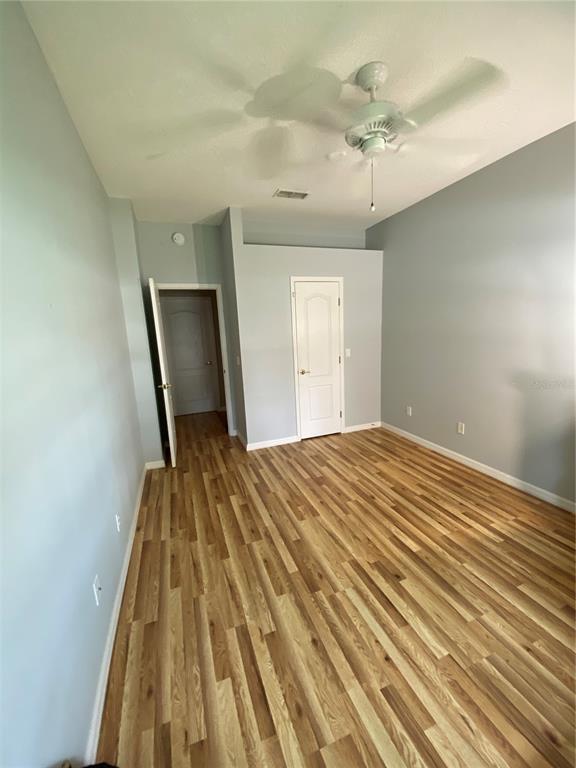 4202 Hammersmith Drive Clermont, FL 34711 - Photo 51 of 73 a bedroom with a bed and a mirror