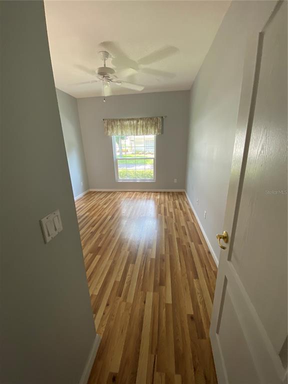 4202 Hammersmith Drive Clermont, FL 34711 - Photo 52 of 73 wooden floor in an empty room with a window