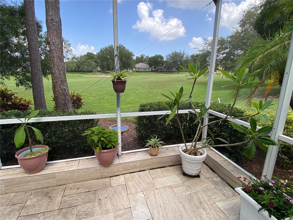 4202 Hammersmith Drive Clermont, FL 34711 - Photo 69 of 73 a view of a balcony with chair potted plants and large tree