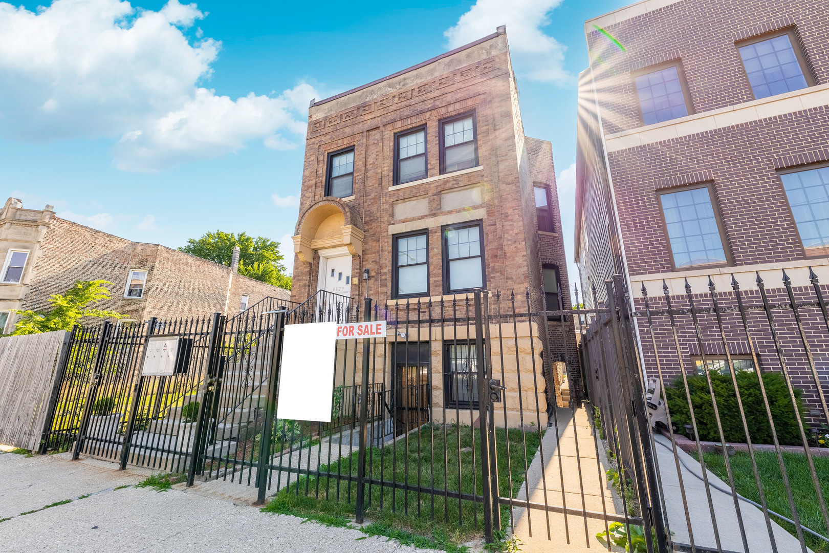 4823 South Indiana Avenue Chicago, IL 60615 - Photo 1 of 30 a view of a brick building next to a yard