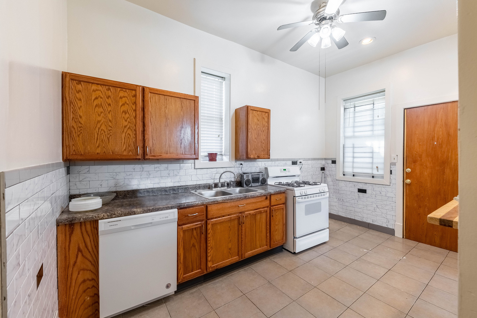4823 South Indiana Avenue Chicago, IL 60615 - Photo 16 of 30 a kitchen with a sink cabinets and window