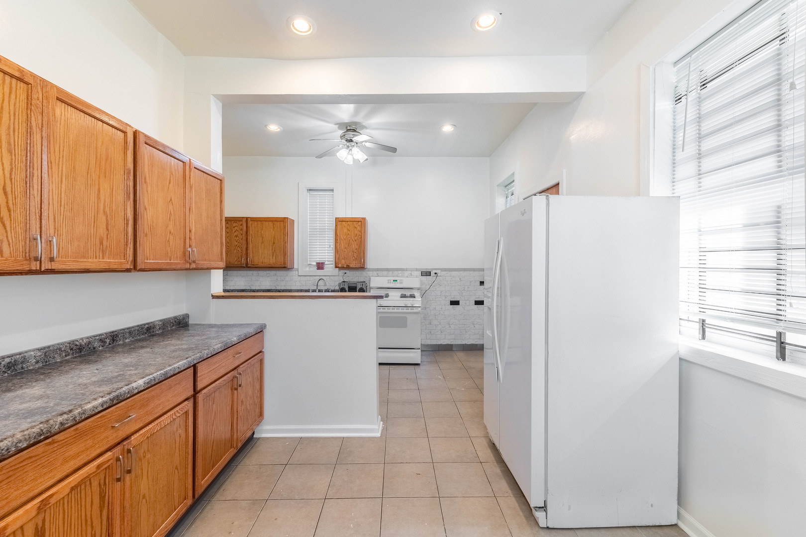 4823 South Indiana Avenue Chicago, IL 60615 - Photo 18 of 30 a kitchen with a refrigerator a sink and cabinets