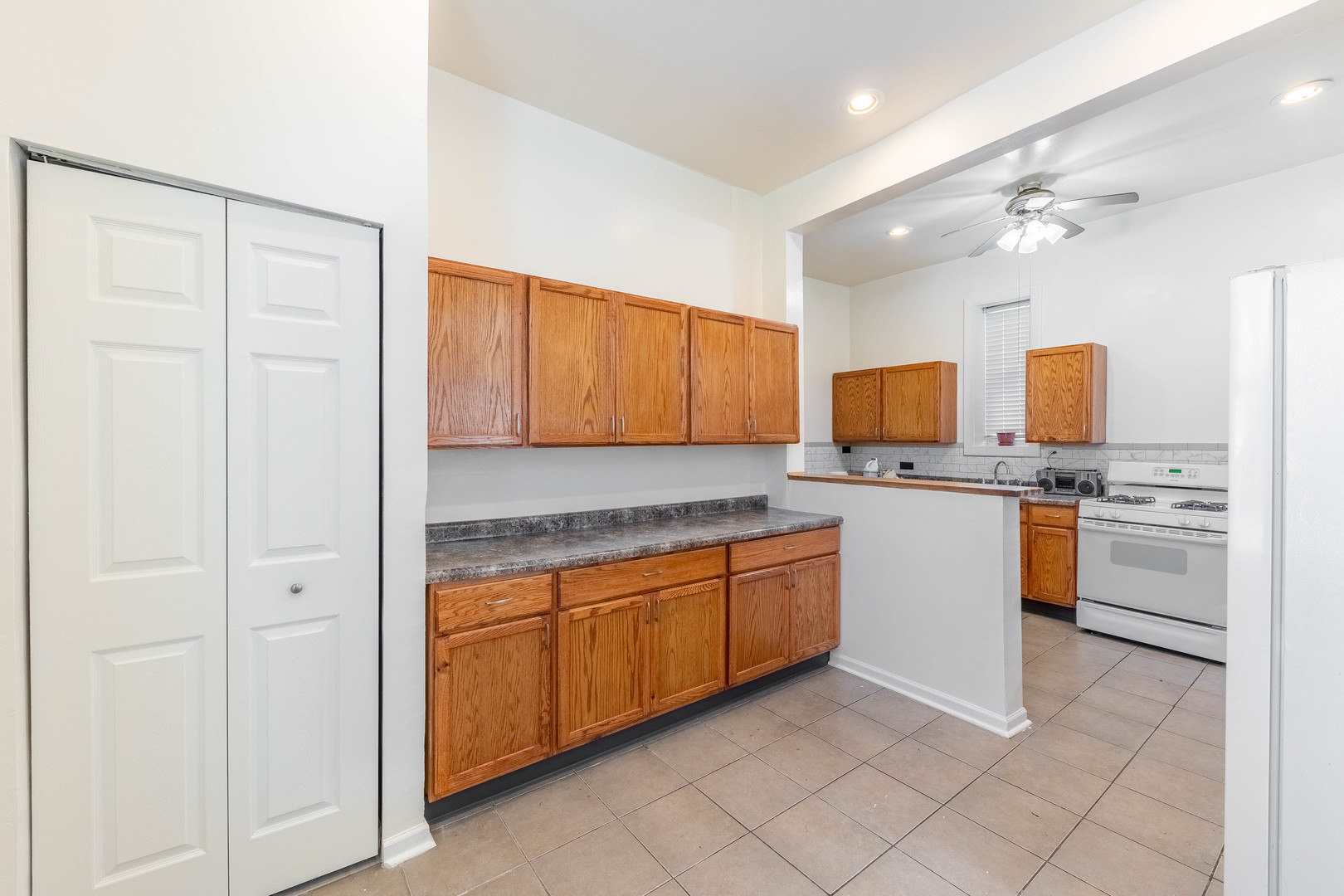 4823 South Indiana Avenue Chicago, IL 60615 - Photo 20 of 30 a kitchen with granite countertop a sink cabinets stainless steel appliances and a window