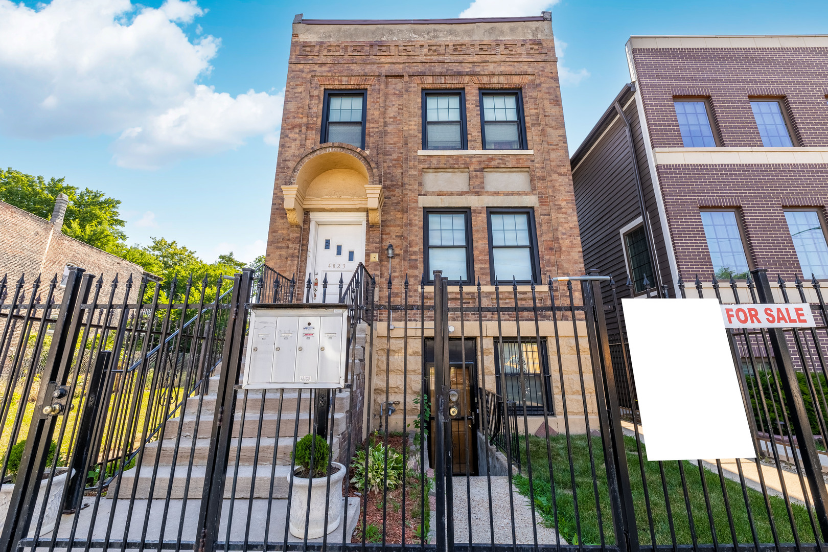 4823 South Indiana Avenue Chicago, IL 60615 - Photo 2 of 30 a view of a brick house with many windows