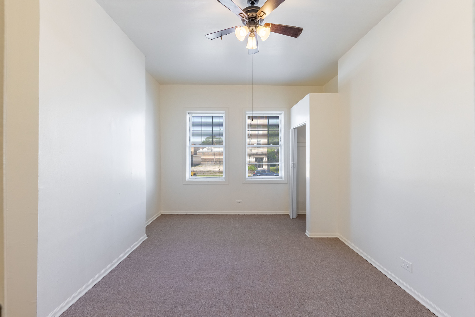 4823 South Indiana Avenue Chicago, IL 60615 - Photo 9 of 30 an empty room with windows and fan