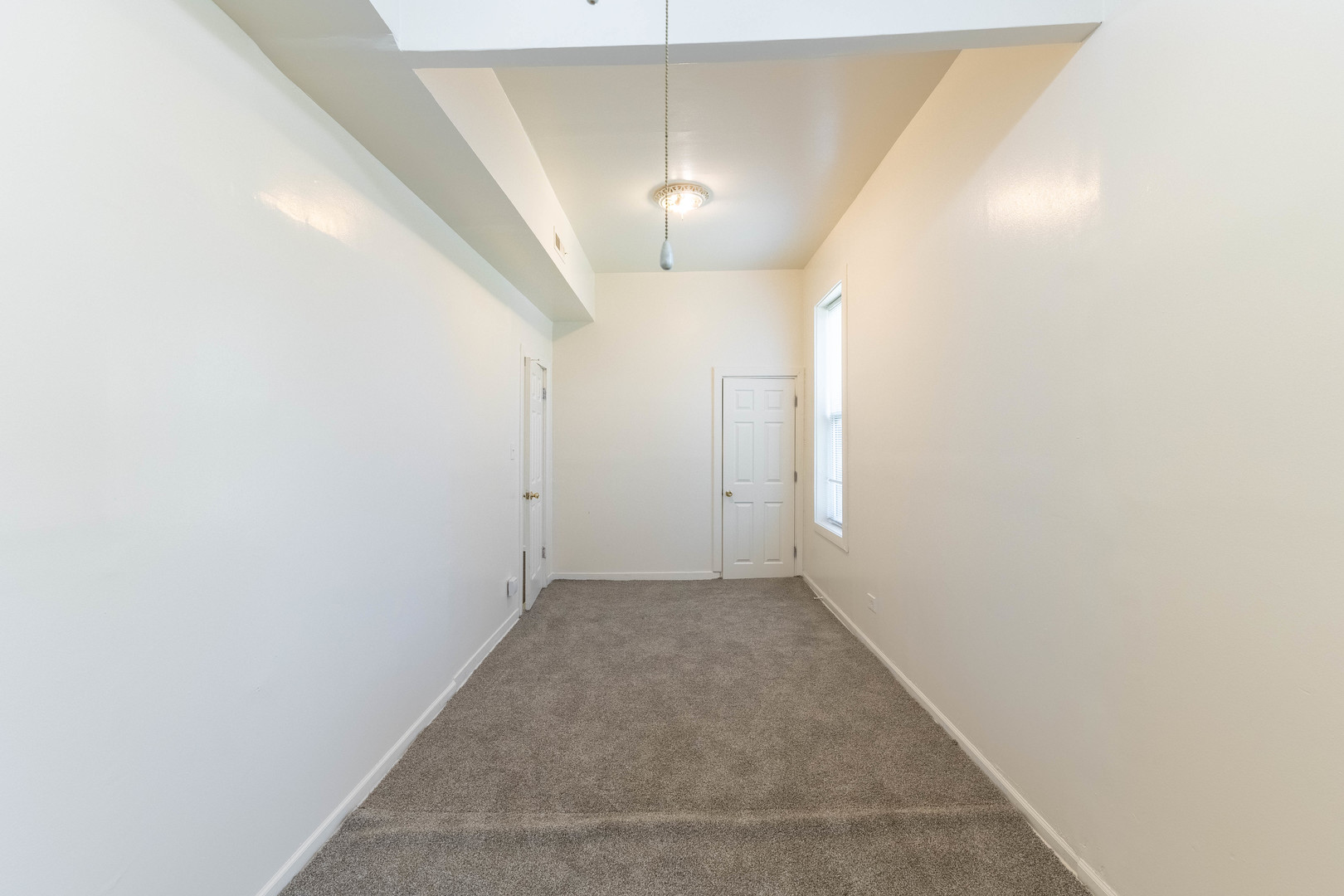 4823 South Indiana Avenue Chicago, IL 60615 - Photo 10 of 30 a view of a hallway with a chandelier