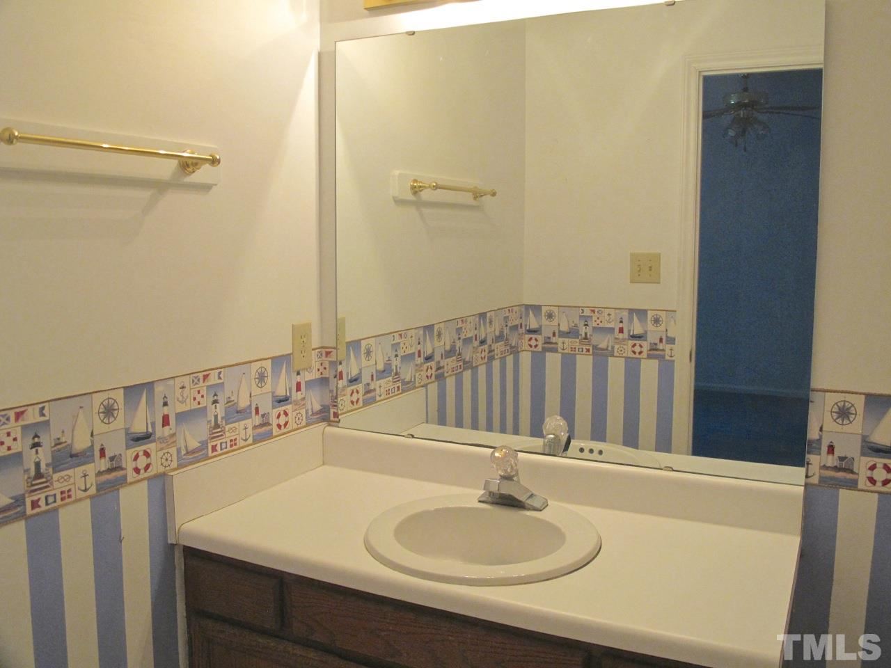 2063 Trexler Court Raleigh, NC 27606 - Photo 14 of 21 a bathroom with a sink and a mirror