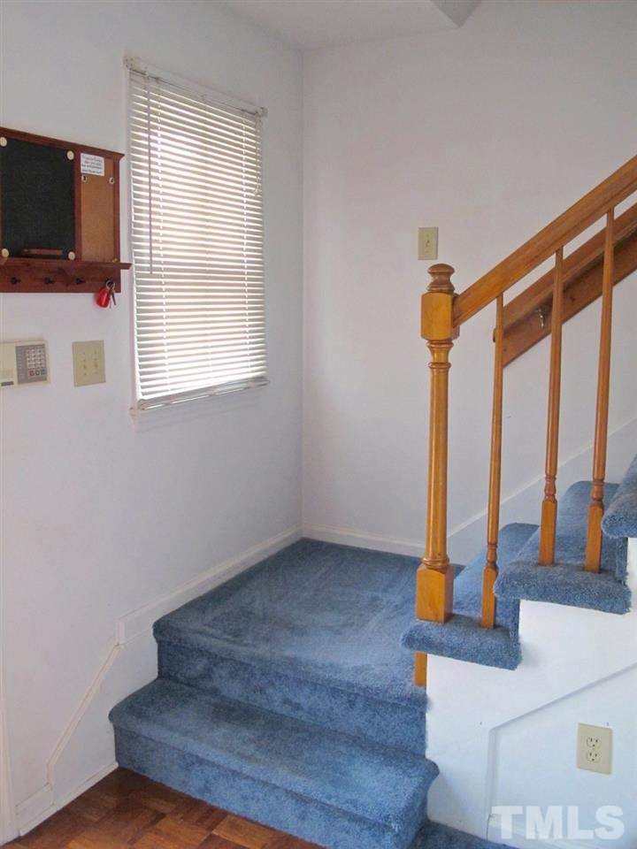2063 Trexler Court Raleigh, NC 27606 - Photo 3 of 21 a view of an empty room with wooden floor and a window