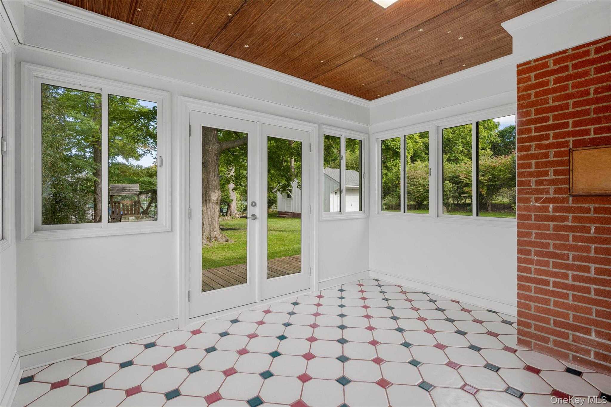 1 Craigside Drive Cold Spring, NY 10516 - Photo 28 of 36 Tiled sunroom with new french doors to the deck and back yard