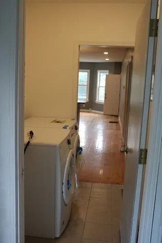 a view of a hallway with washer and dryer