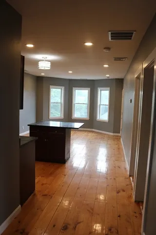 a view of entryway with kitchen and window