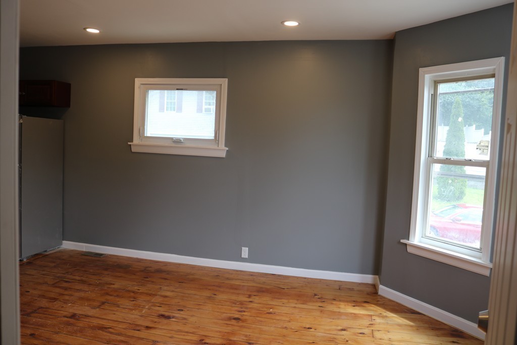 69 Catharine Street, Unit 3 Worcester, MA 01605 - Photo 5 of 17 a view of an empty room with wooden floor and a window