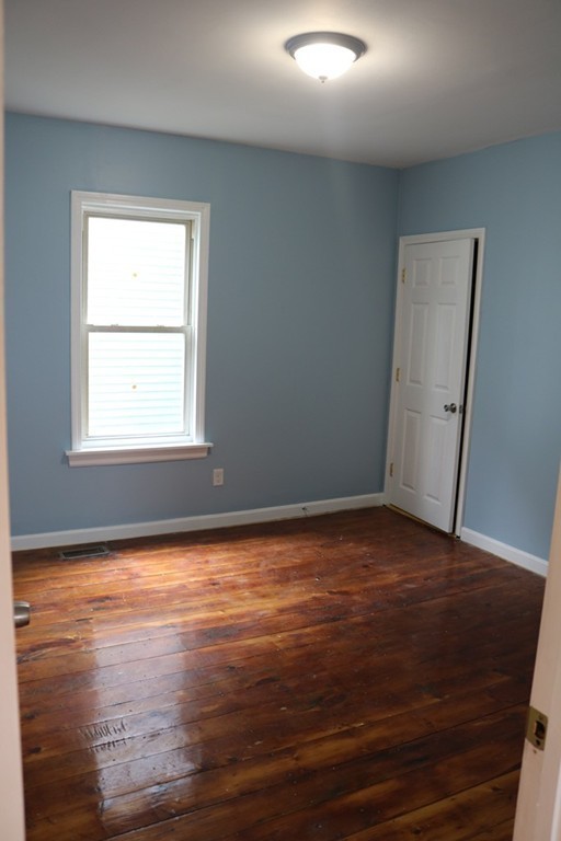 69 Catharine Street, Unit 3 Worcester, MA 01605 - Photo 7 of 17 a view of a room with wooden floor and cabinet