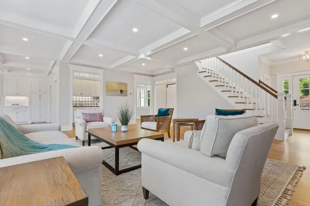 a living room with furniture and kitchen view